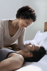 Couple in bed looking at each other