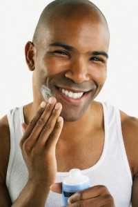 African American man applying face cream