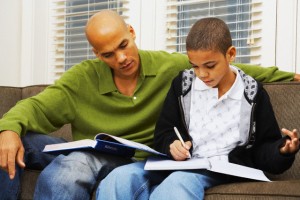 Man Helping Son with Homework
