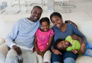 Family sitting on sofa together