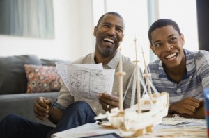 Father and son building ship model at home