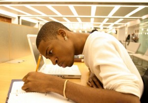 Side profile of a young man studying