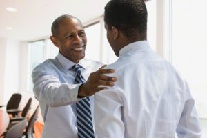 Black businessmen talking in office