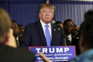 U.S. Republican presidential candidate Donald Trump surrounded by members of Atlanta's black clergy speaks at a news conference prior to a rally in Norcross, Georgia