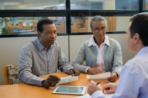 Mature couple preparing to sign loan contract