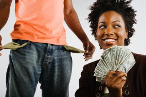 African American woman holding money next to man with empty pockets
