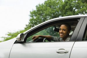 Smiling Young Man Driving