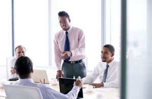 2017-envisio-business-consultants-business-consultants-black-man-standing-in-meeting