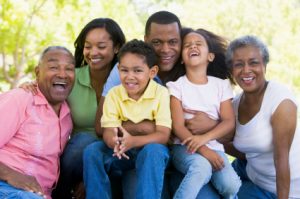 Extended family sitting outdoors smiling