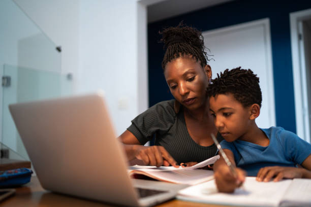 Mother helping son with homework at home