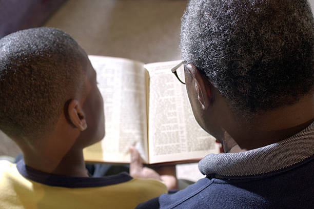 Grandfather and Grandson reading the Bible.