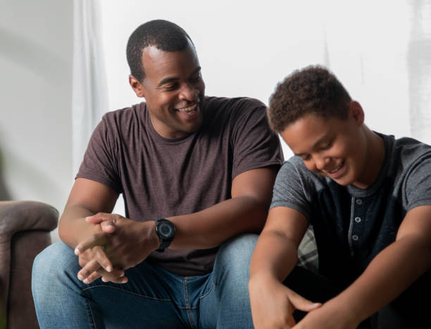 Black Dad and son talking. Deep convo.